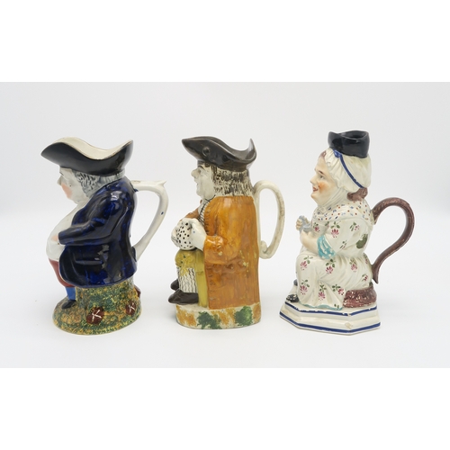 2222 - A STAFFORDSHIRE 18TH CENTURY TOBY JUGmodelled sitting holding a jug, his cloak of an ochre colour, t... 