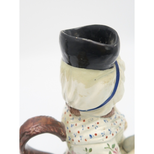 2222 - A STAFFORDSHIRE 18TH CENTURY TOBY JUGmodelled sitting holding a jug, his cloak of an ochre colour, t... 