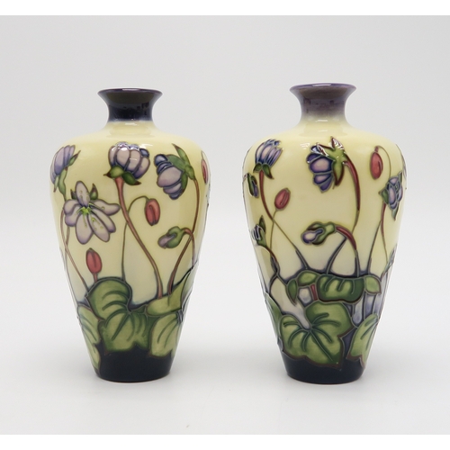 2228 - A PAIR OF MOORCROFT HEPATICA PATTERN VASESof tapering form, 15.5cm high together with a small jardin... 