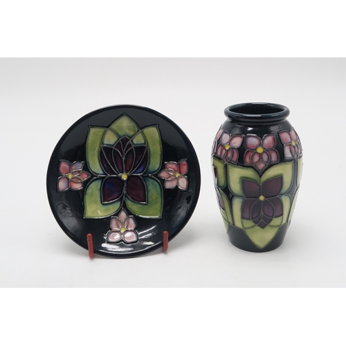 2234 - THREE PIECES OF MOORCROFT VIOLET PATTERN CERAMICSincluding a table lamp, a vase 11cm high and a coas... 