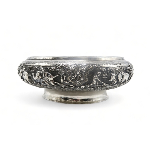 2363 - A BURMESE WHITE METAL PRESENTATION BOWLDecorated with oxen pulling carts and a boat divided by scrol... 