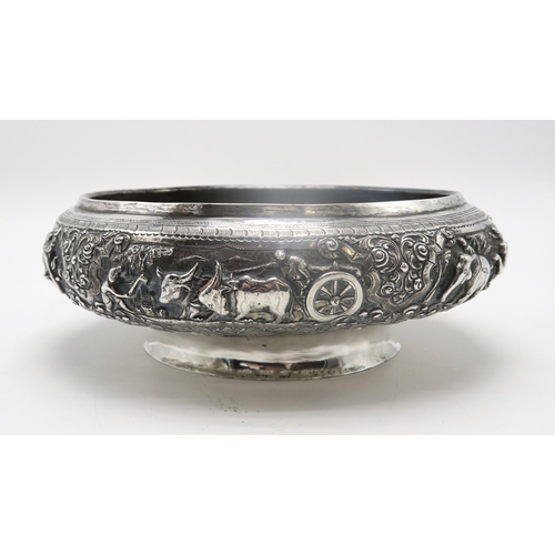 2363 - A BURMESE WHITE METAL PRESENTATION BOWLDecorated with oxen pulling carts and a boat divided by scrol... 