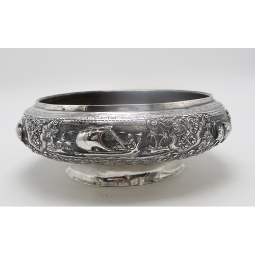 2363 - A BURMESE WHITE METAL PRESENTATION BOWLDecorated with oxen pulling carts and a boat divided by scrol... 