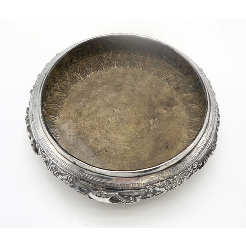 2363 - A BURMESE WHITE METAL PRESENTATION BOWLDecorated with oxen pulling carts and a boat divided by scrol... 