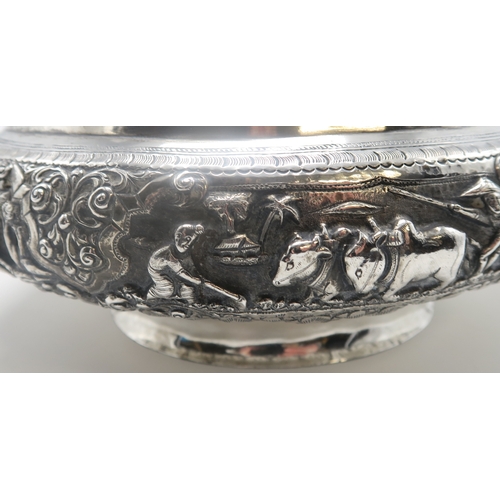 2363 - A BURMESE WHITE METAL PRESENTATION BOWLDecorated with oxen pulling carts and a boat divided by scrol... 