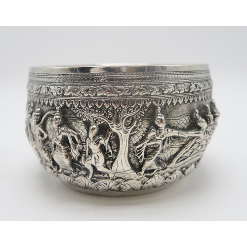 2364 - A BURMESE WHITE METAL BOWL Decorated with a frieze of dancing figures,divided by trees and with... 