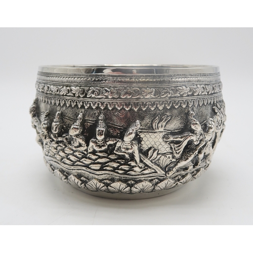 2364 - A BURMESE WHITE METAL BOWL Decorated with a frieze of dancing figures,divided by trees and with... 