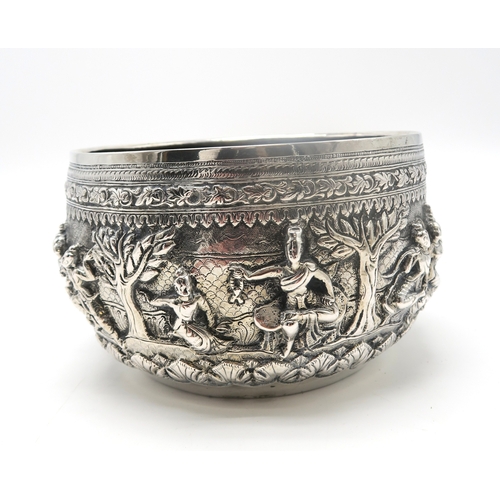 2364 - A BURMESE WHITE METAL BOWL Decorated with a frieze of dancing figures,divided by trees and with... 