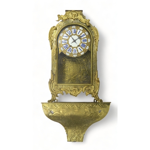 2224 - A LARGE FRENCH BRASS TIMEPIECEof Rococo style, the dial with white markers with blue roman numeral d... 