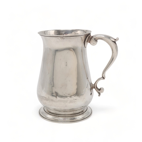 2477 - A GEORGE II SILVER TANKARDLondon 1757, maker's mark rubbed, of plain baluster form, with a scrolling... 