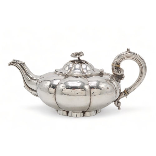 2481 - A WILLIAM IV SILVER TEAPOTby Charles Gordon, London 1833, of compressed melon form, with a floral fi... 