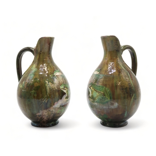 2212 - A PAIR OF FRENCH POTTERY EWERSeach painted with two frogs on naturalistic ground, each signed to the... 