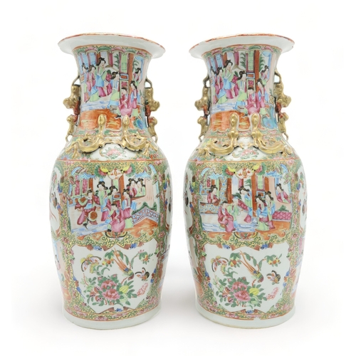 2362 - A PAIR OF CANTON BALUSTER VASESPainted with panels of figures, birds, insects and foliage, within gi... 