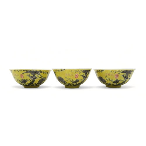 2367 - THREE CHINESE YELLOW GROUND BOWLSPainted with birds amongst scattered flowers and tendrils, gilt sea... 