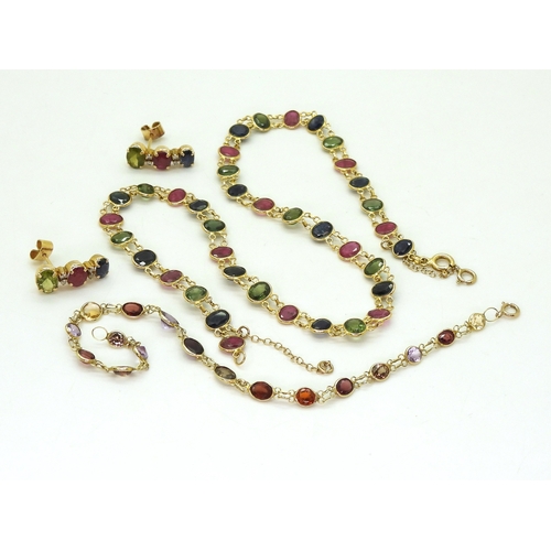 2740 - A SUITE OF MULTICOLOURED GEM JEWELSto include and 18ct gold necklace spectacle set with oval cut rub... 