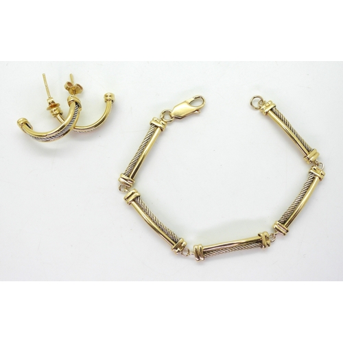 2741 - AN ARABIC GOLD SETcomprising of bracelet and earrings with white gold cable pattern details. Length ... 