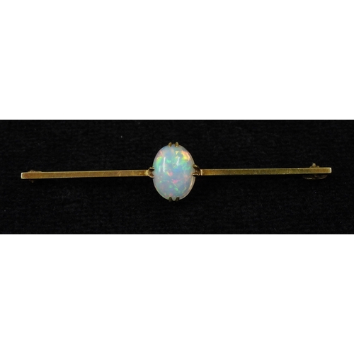 2743 - A 15CT GOLD OPAL BAR BROOCHset with an oval cabochon opal of 10mm x 8mm, length 5.5cm, weight 3.7gms... 