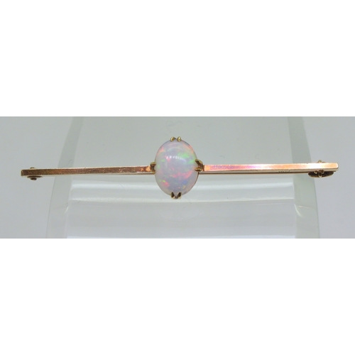 2743 - A 15CT GOLD OPAL BAR BROOCHset with an oval cabochon opal of 10mm x 8mm, length 5.5cm, weight 3.7gms... 