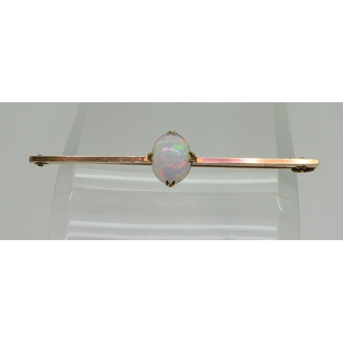 2743 - A 15CT GOLD OPAL BAR BROOCHset with an oval cabochon opal of 10mm x 8mm, length 5.5cm, weight 3.7gms... 