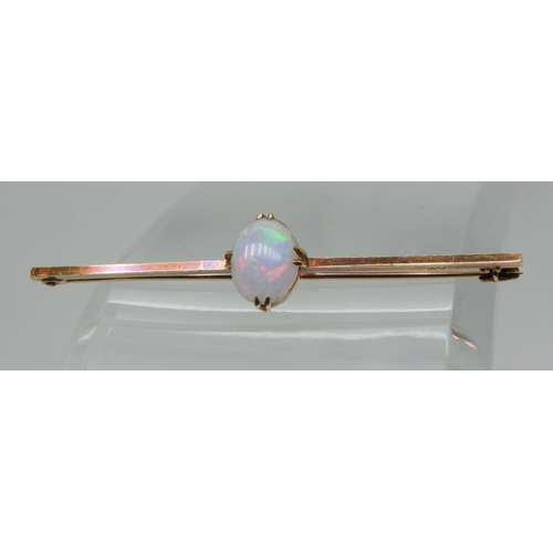 2743 - A 15CT GOLD OPAL BAR BROOCHset with an oval cabochon opal of 10mm x 8mm, length 5.5cm, weight 3.7gms... 