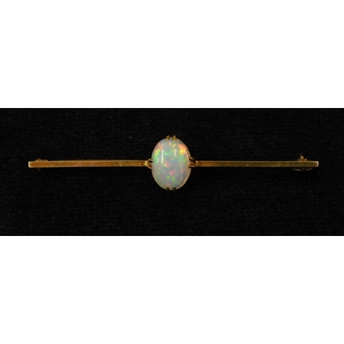 2743 - A 15CT GOLD OPAL BAR BROOCHset with an oval cabochon opal of 10mm x 8mm, length 5.5cm, weight 3.7gms... 