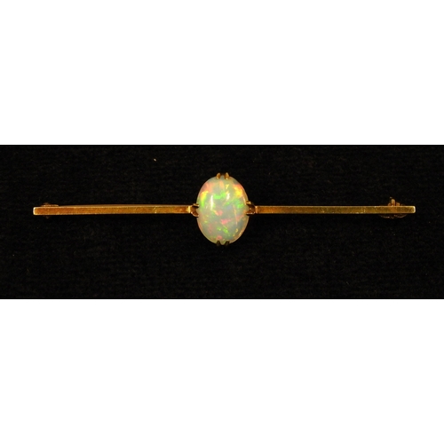 2743 - A 15CT GOLD OPAL BAR BROOCHset with an oval cabochon opal of 10mm x 8mm, length 5.5cm, weight 3.7gms... 