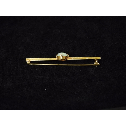 2743 - A 15CT GOLD OPAL BAR BROOCHset with an oval cabochon opal of 10mm x 8mm, length 5.5cm, weight 3.7gms... 