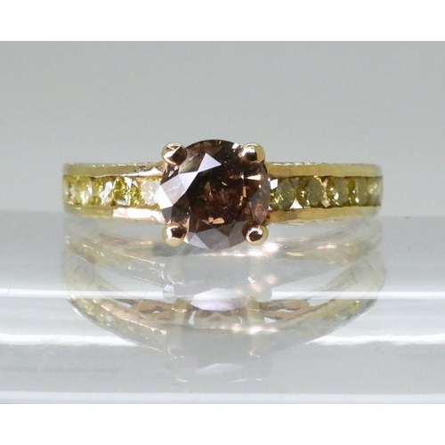 2744 - A 9CT GOLD DIAMOND RINGset with a  brown diamond of estimated approx 0.98cts, flanked by 12 yellow d... 