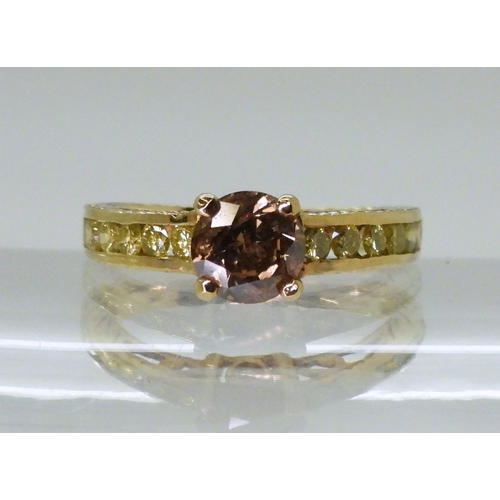 2744 - A 9CT GOLD DIAMOND RINGset with a  brown diamond of estimated approx 0.98cts, flanked by 12 yellow d... 