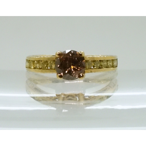 2744 - A 9CT GOLD DIAMOND RINGset with a  brown diamond of estimated approx 0.98cts, flanked by 12 yellow d... 