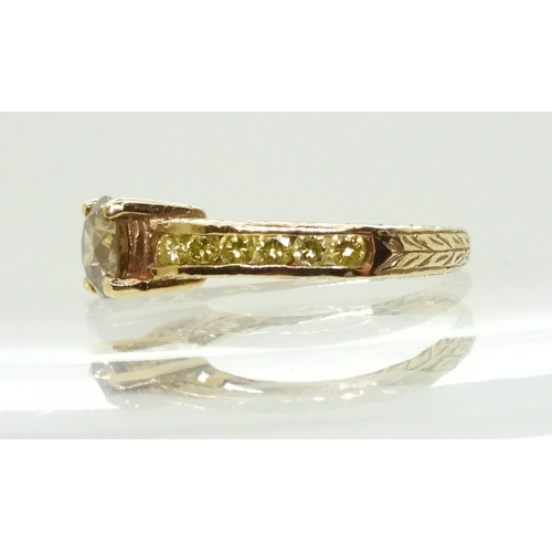 2744 - A 9CT GOLD DIAMOND RINGset with a  brown diamond of estimated approx 0.98cts, flanked by 12 yellow d... 