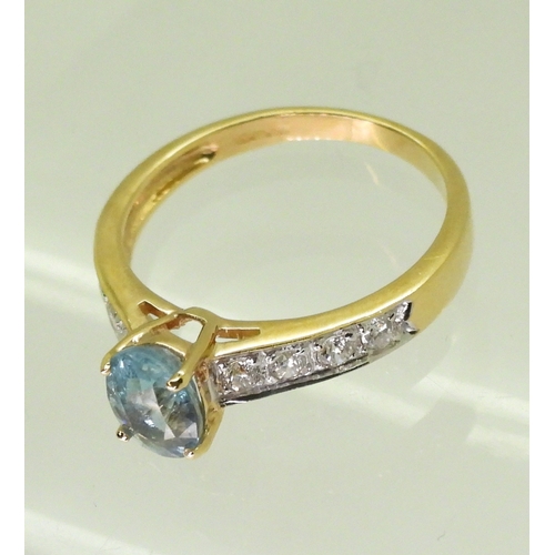 2746 - AN 18CT GOLD AQUAMARINE AND DIAMOND RINGset with an oval cut aquamarine, with four pave set brillian... 