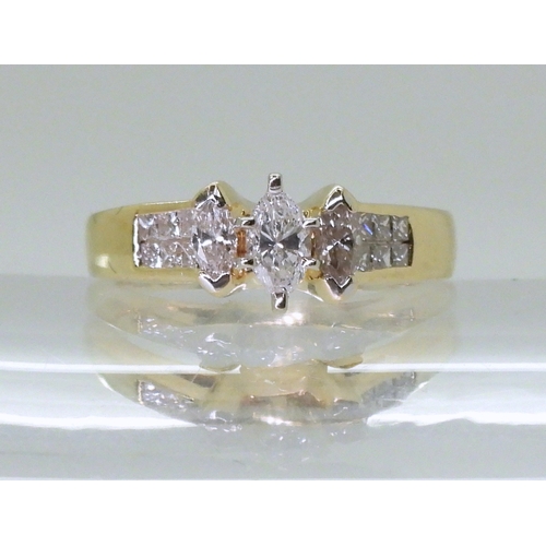 2749 - A 14CT GOLD DIAMOND CLUSTER RINGset with three marquis cut diamonds and twelve princess cut diamonds... 