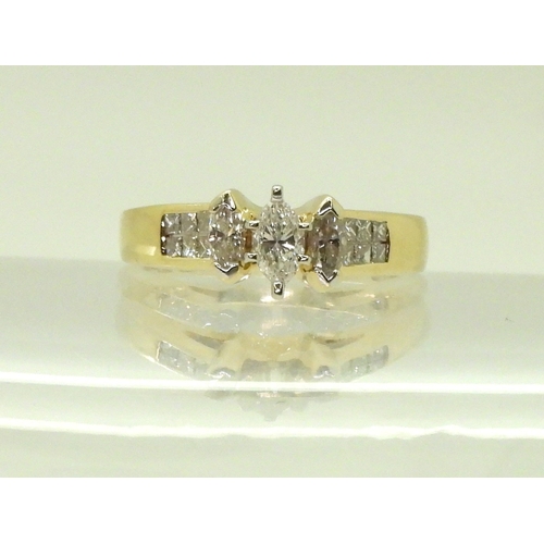 2749 - A 14CT GOLD DIAMOND CLUSTER RINGset with three marquis cut diamonds and twelve princess cut diamonds... 