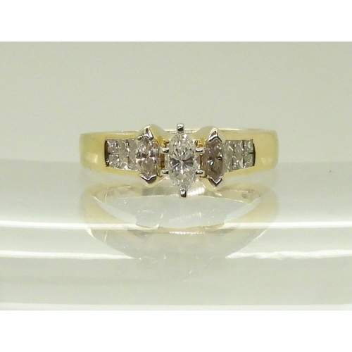 2749 - A 14CT GOLD DIAMOND CLUSTER RINGset with three marquis cut diamonds and twelve princess cut diamonds... 