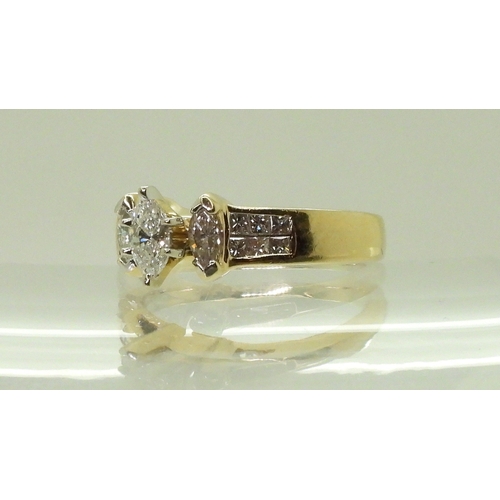 2749 - A 14CT GOLD DIAMOND CLUSTER RINGset with three marquis cut diamonds and twelve princess cut diamonds... 