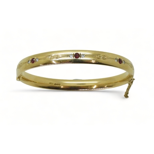 2750 - RUBY AND DIAMOND BANGLEmounted in heavy gauge solid 9ct gold, grain set with six diamonds with an es... 