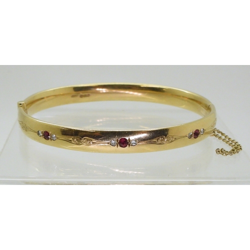 2750 - RUBY AND DIAMOND BANGLEmounted in heavy gauge solid 9ct gold, grain set with six diamonds with an es... 