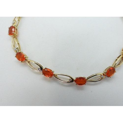 2753 - A FIRE OPAL & DIAMOND BRACELETset in 9ct yellow gold, the opal s are approx 5.3mm x 3.5mm, with ... 