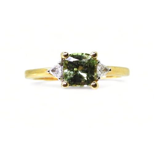 2757 - AN APATITE AND DIAMOND RINGset with a cushion cut pale green apatite, approx 6mm x 6mm, with two tri... 