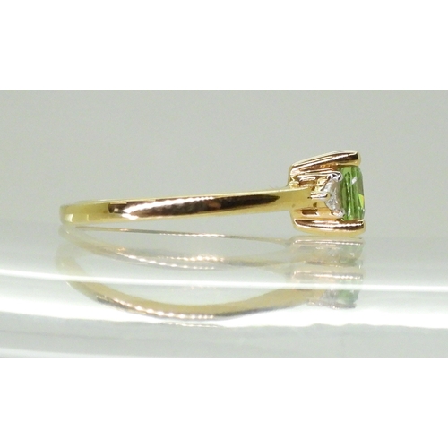 2757 - AN APATITE AND DIAMOND RINGset with a cushion cut pale green apatite, approx 6mm x 6mm, with two tri... 