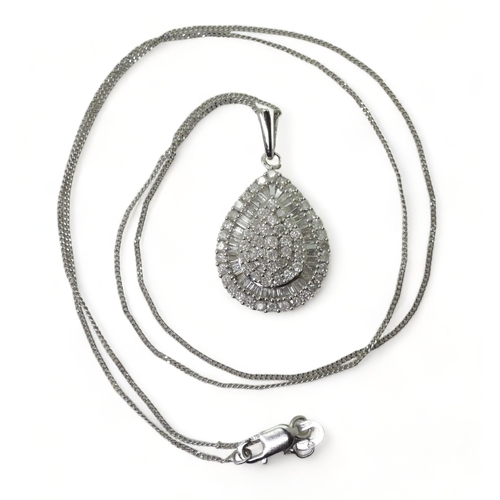 2764 - A DIAMOND PENDANTthe 9ct white gold pear shaped pendant is set with pave and channel set brilliant a... 