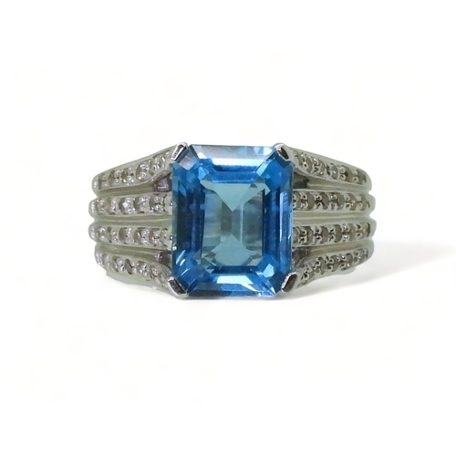 2766 - A BLUE TOPAZ & DIAMOND RINGmade by the jewellery channel in 14k white gold, the step cut blue to... 