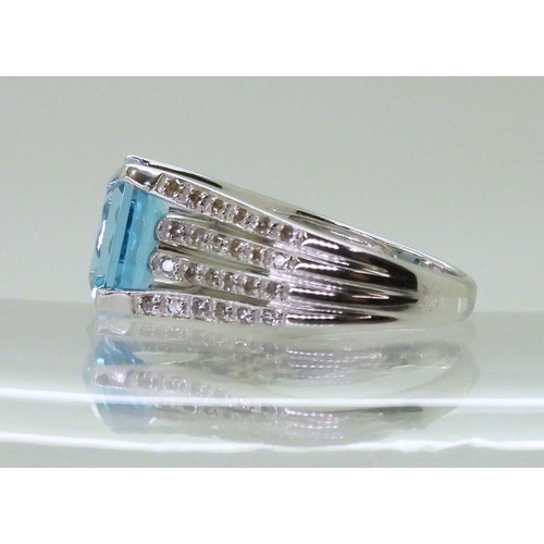 2766 - A BLUE TOPAZ & DIAMOND RINGmade by the jewellery channel in 14k white gold, the step cut blue to... 