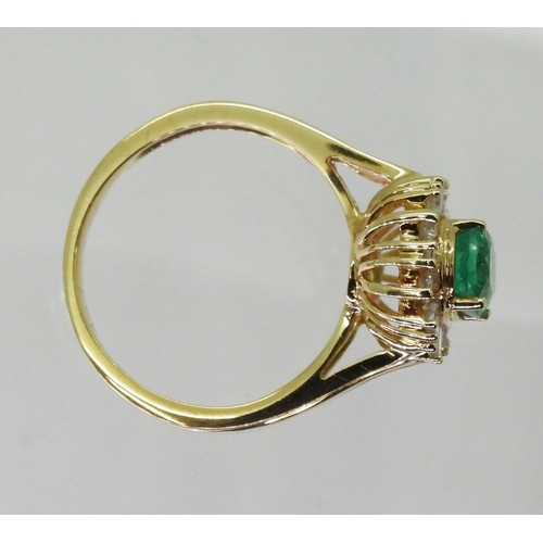 2770 - AN 18CT EMERALD & DIAMOND RINGset with an oval cut emerald of 7mm x 5.6mm, with brilliant and ba... 