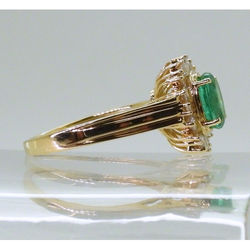 2770 - AN 18CT EMERALD & DIAMOND RINGset with an oval cut emerald of 7mm x 5.6mm, with brilliant and ba... 