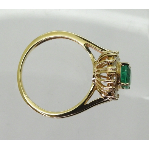 2770 - AN 18CT EMERALD & DIAMOND RINGset with an oval cut emerald of 7mm x 5.6mm, with brilliant and ba... 