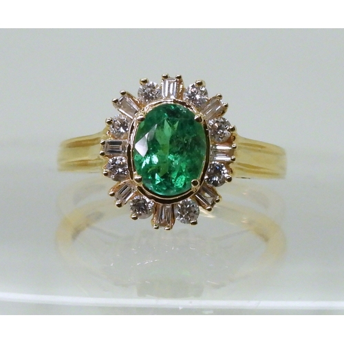 2770 - AN 18CT EMERALD & DIAMOND RINGset with an oval cut emerald of 7mm x 5.6mm, with brilliant and ba... 