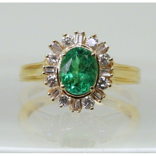 2770 - AN 18CT EMERALD & DIAMOND RINGset with an oval cut emerald of 7mm x 5.6mm, with brilliant and ba... 