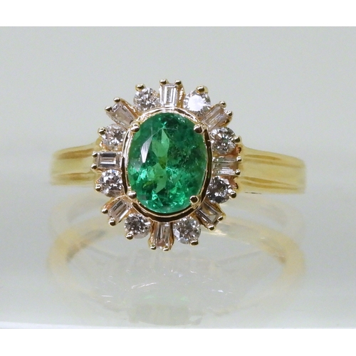 2770 - AN 18CT EMERALD & DIAMOND RINGset with an oval cut emerald of 7mm x 5.6mm, with brilliant and ba... 